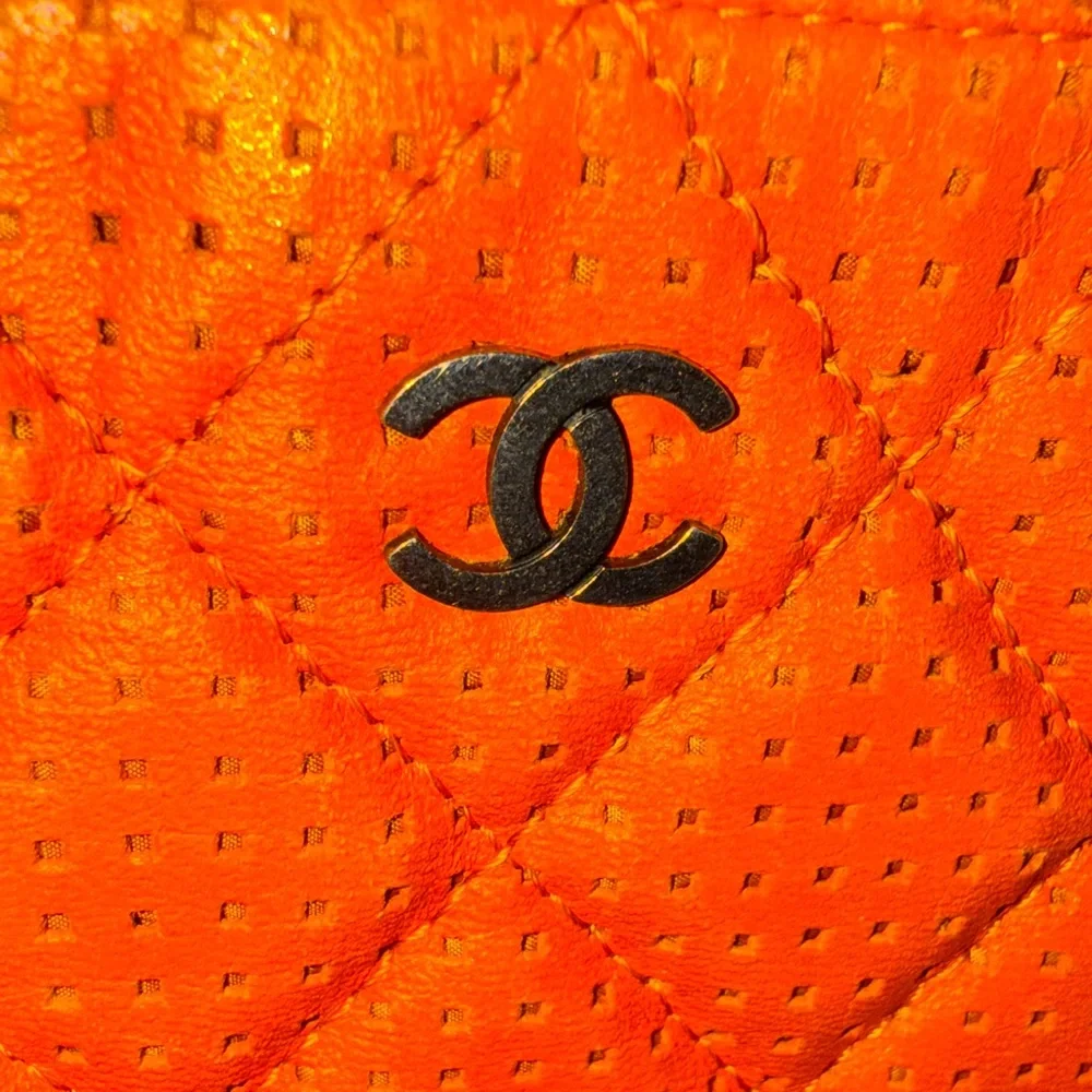 Chanel orange perforated quilted leather O case clutch pouch NWOT